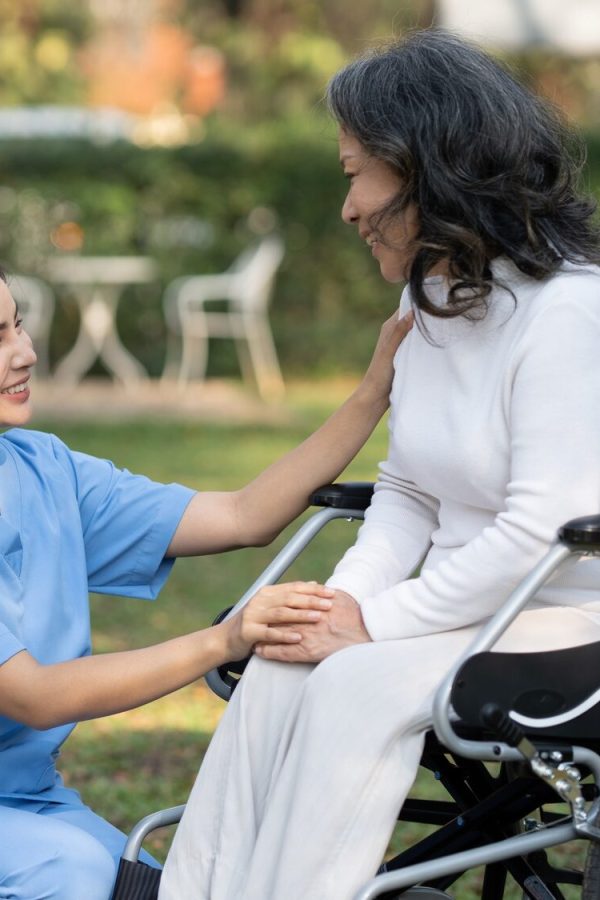 Elderly care and consulting patient. nurse volunteer at nursing home for charity work, talking with